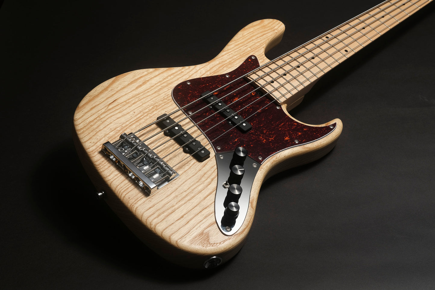 Electric guitar with a wooden finish on a dark background