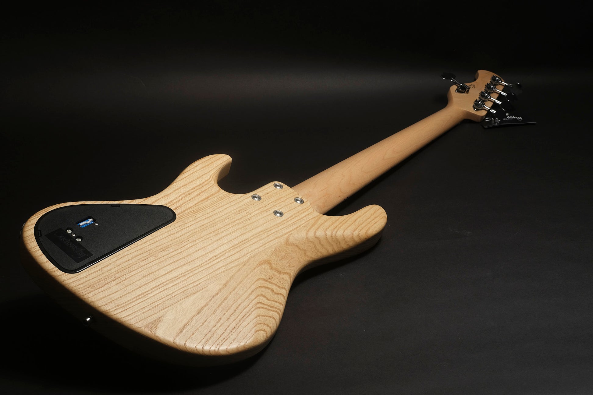 Electric guitar with a wooden body on a black background