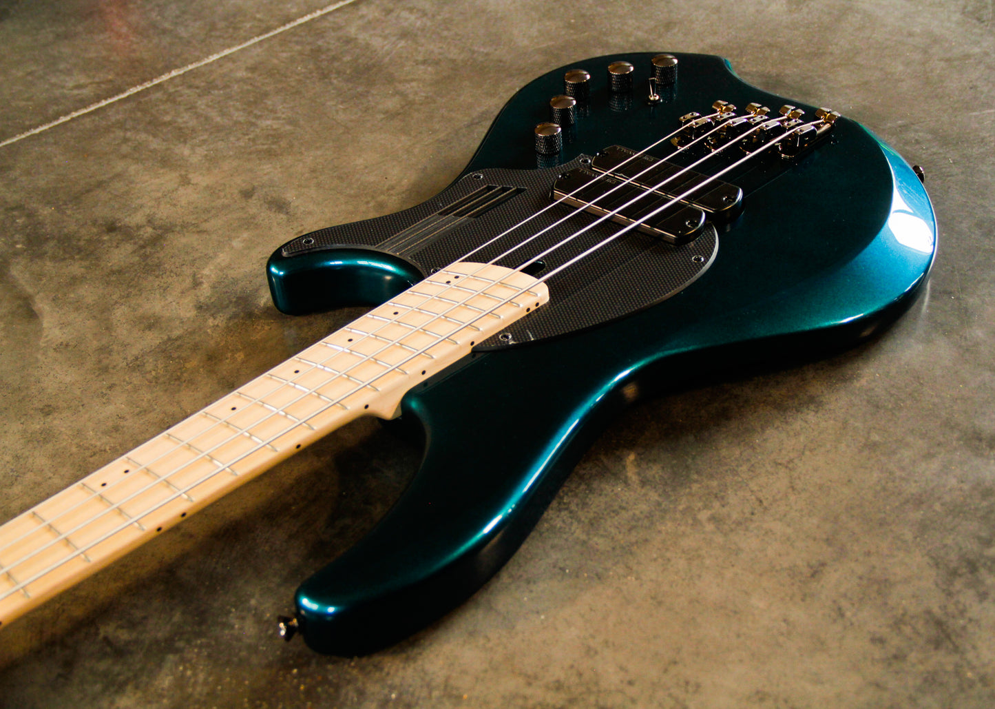 Dingwall Guitars NG2 'Black Forest green' 4-string bass guitar with a metallic finish on the body, maple neck, and fingerboard.
